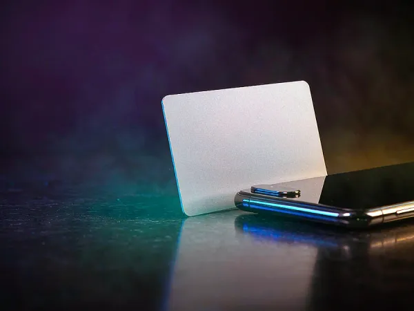 bro444 + Blank card standing beside a smartphone