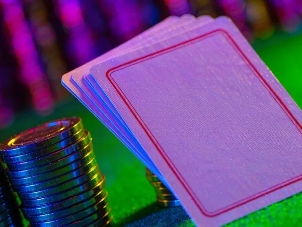 bro444 + Face-down playing cards beside colourful casino chips